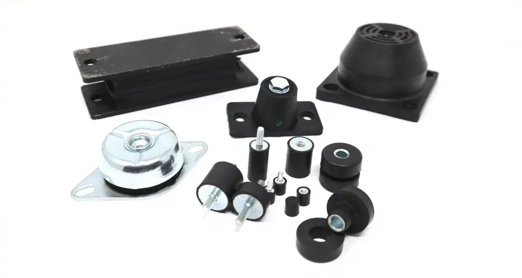 Industrial anti-vibration mounts installed under heavy machinery — cylindrical rubber-metal isolators