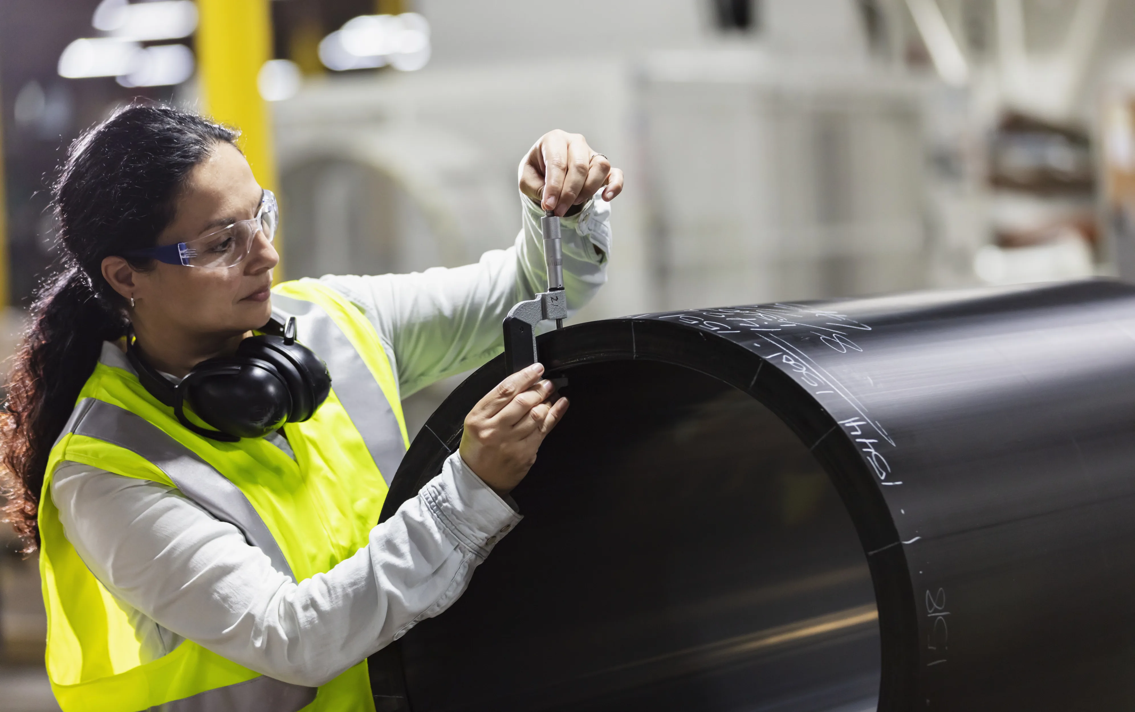 Technician measuring a large steel cylinder bore — dimensional verification at the Santoo KEZAD workshop