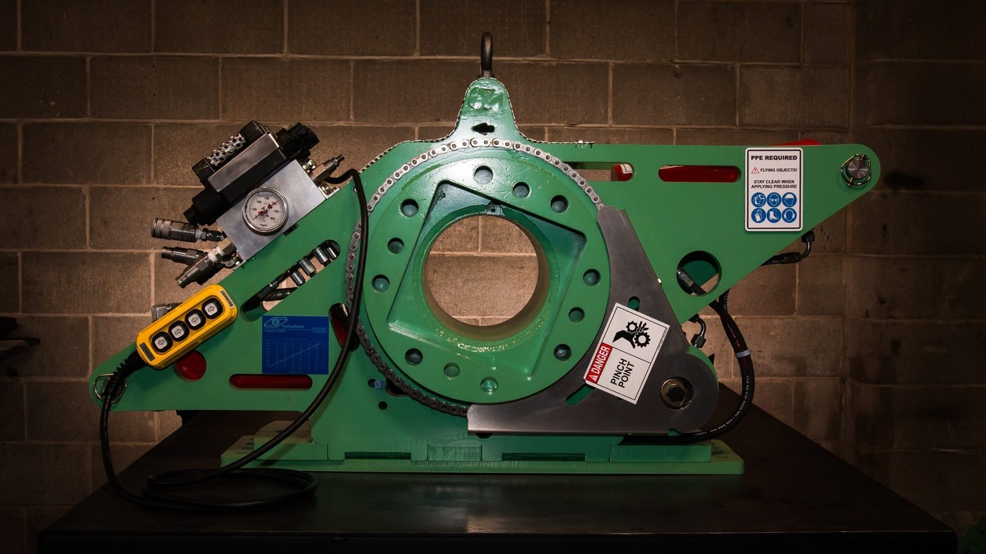 Large hydraulic torque tool mounted on heavy industrial cylinder