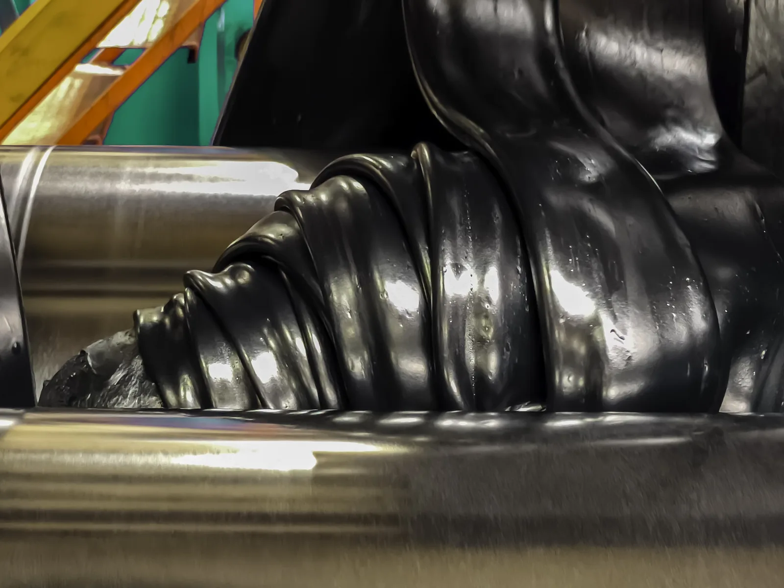 Rubber elastomer compound being processed on a mill — in-house compound development at Santoo KEZAD