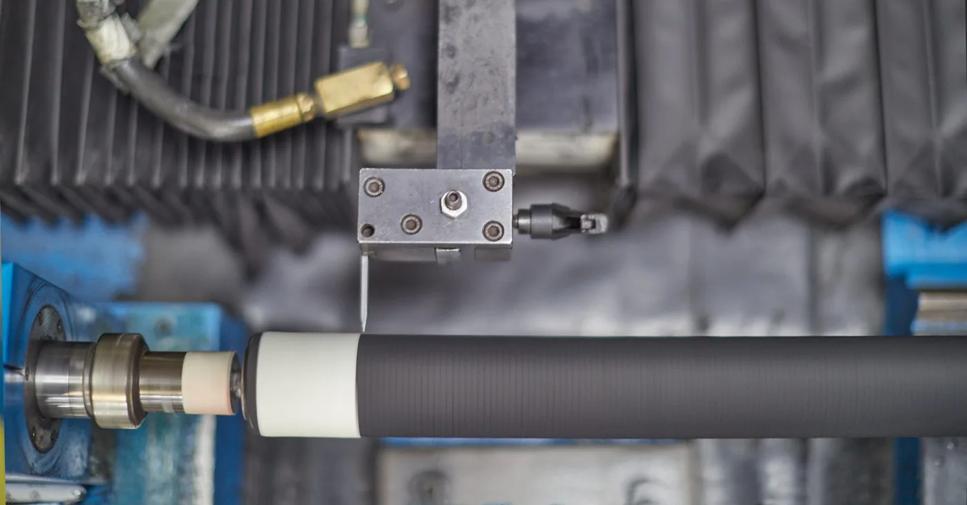 Lathe with cutting tool machining a cylindrical rod — surface preparation before chrome plating